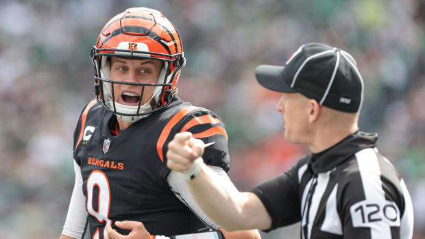 Sep 25, 2022; East Rutherford, New Jersey, USA; Cincinnati Bengals quarterback Joe Burrow (9) talks with side judge Jonah Monroe (120) during the first half against the New York Jets at MetLife Stadium. Mandatory Credit: Vincent Carchietta-USA TODAY Sports
